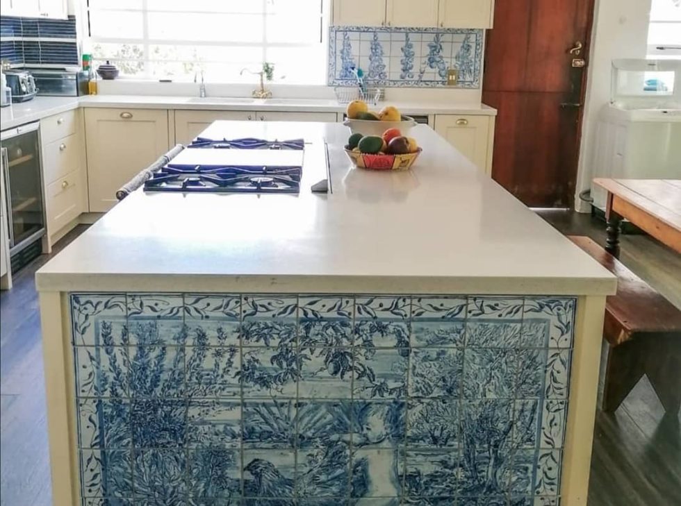 kitchen island in yellow with sleek white countertop and stove