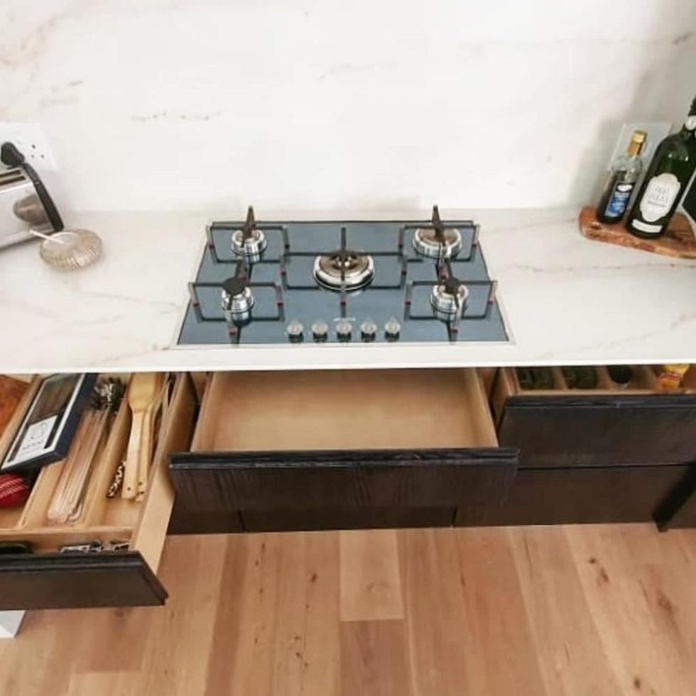 black kitchen drawers pulled open