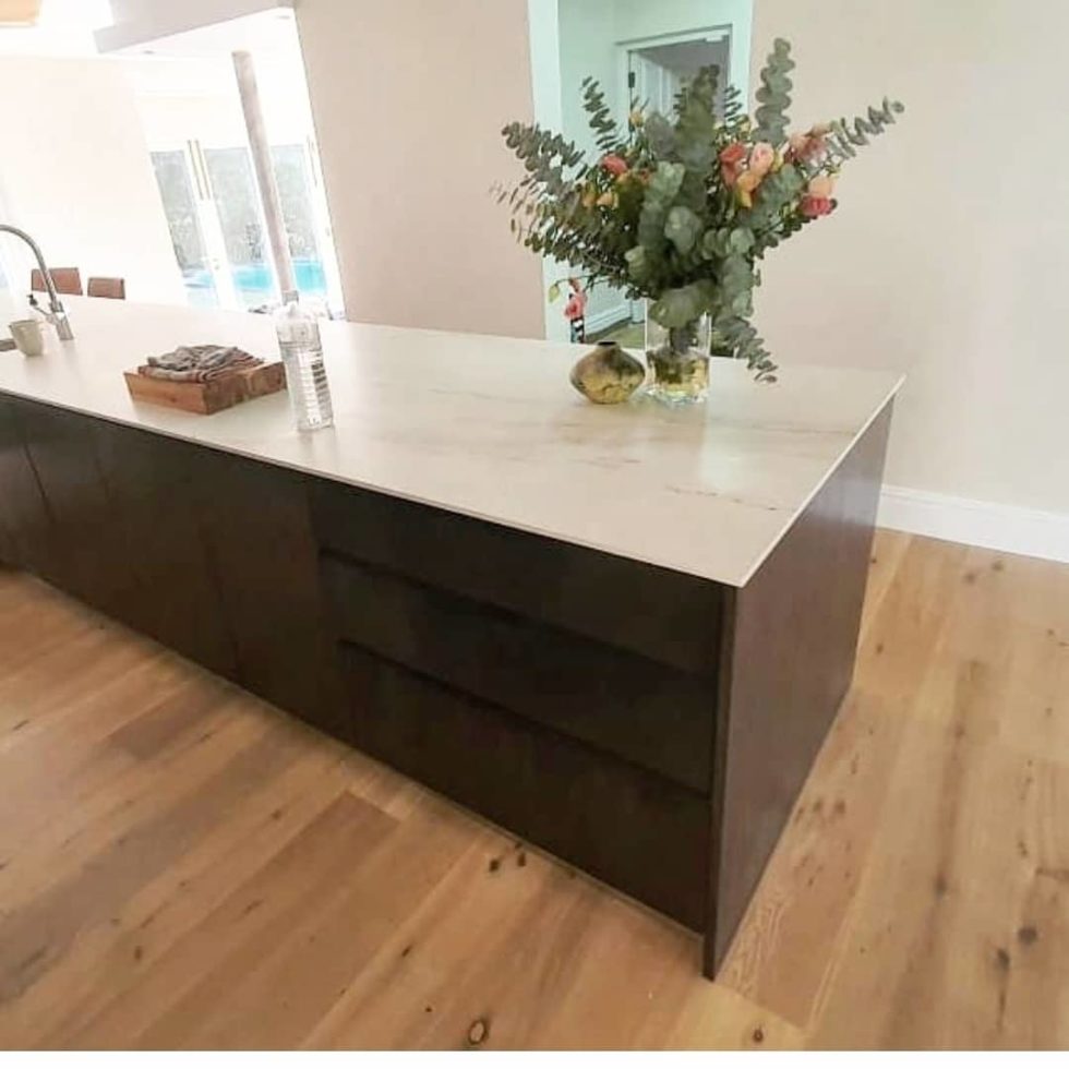 white kitchen countertop paired with brown floor