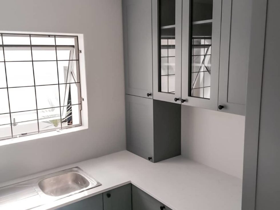 white stone countertop paired with dark grey cabinets