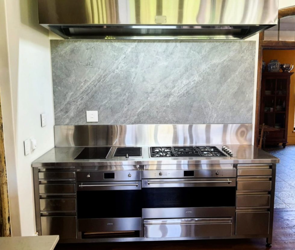 grey backsplash paired with large silver stove
