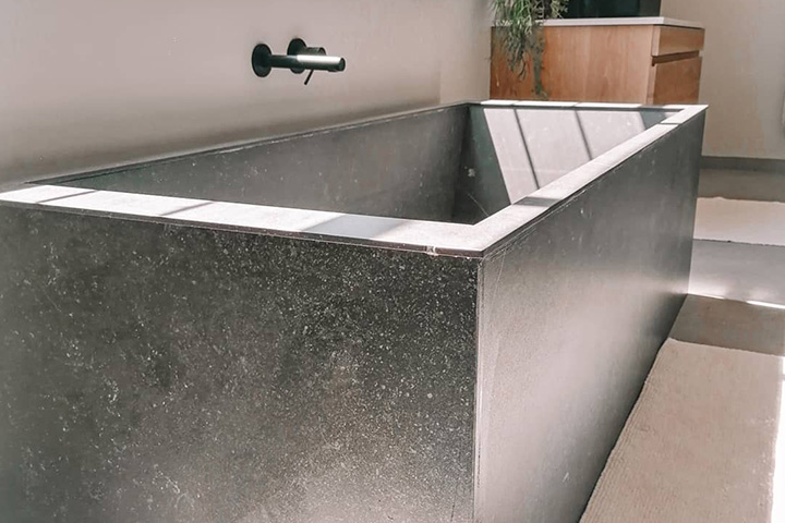 Grey natural stone bathtub in home interior