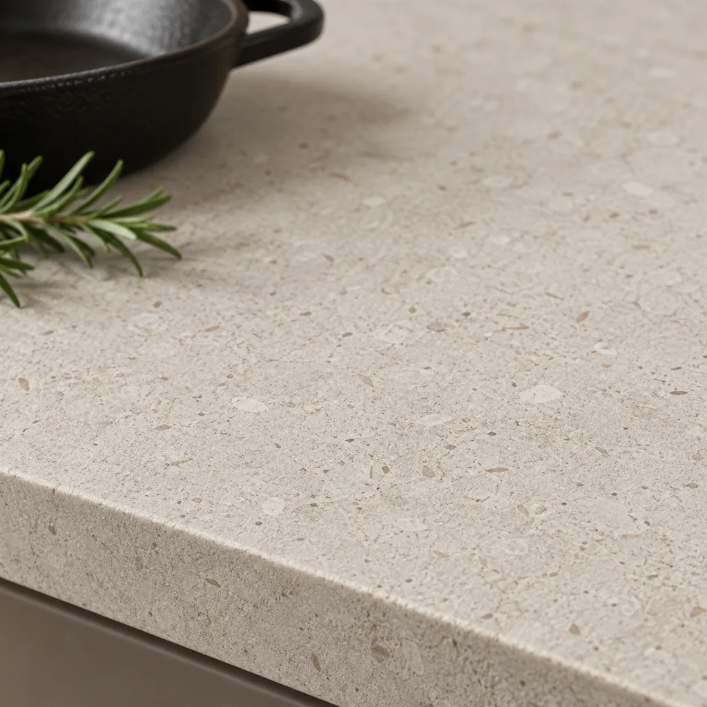 Close-up of a matte pale greige porcelain top with fine flecks, Dekton Nebbia, with a square edge